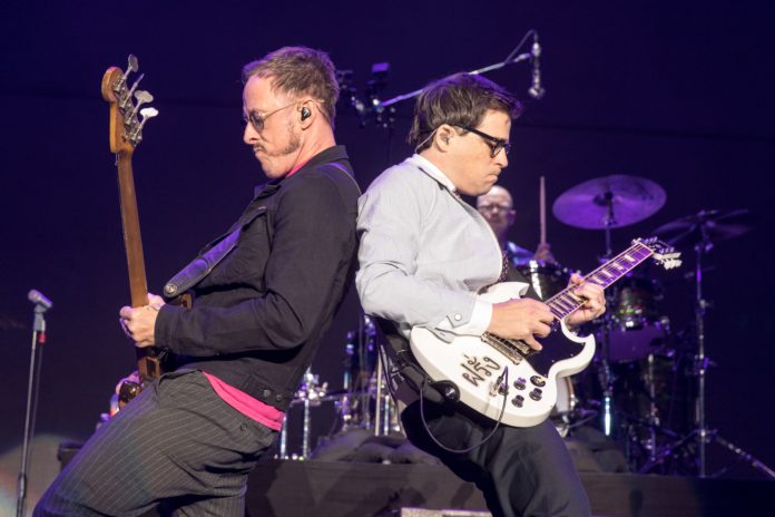 Scott Shriner and Rivers Cuomo of Weezer performing in 2017