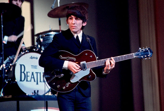 George Harrison of The Beatles performs at 