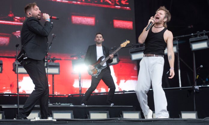 Rou Reynolds (R) from Enter Shikari as a guest with You Me at Six at Reading Festival in August 2023