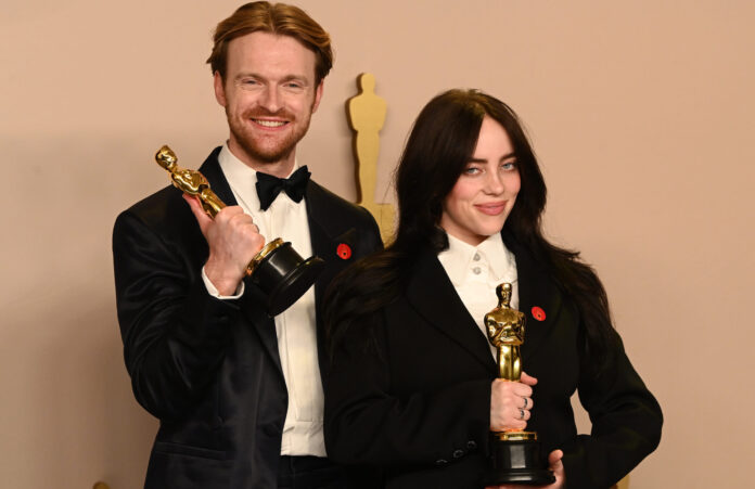 Billie Eilish and Finneas O'Connell with their awards for 